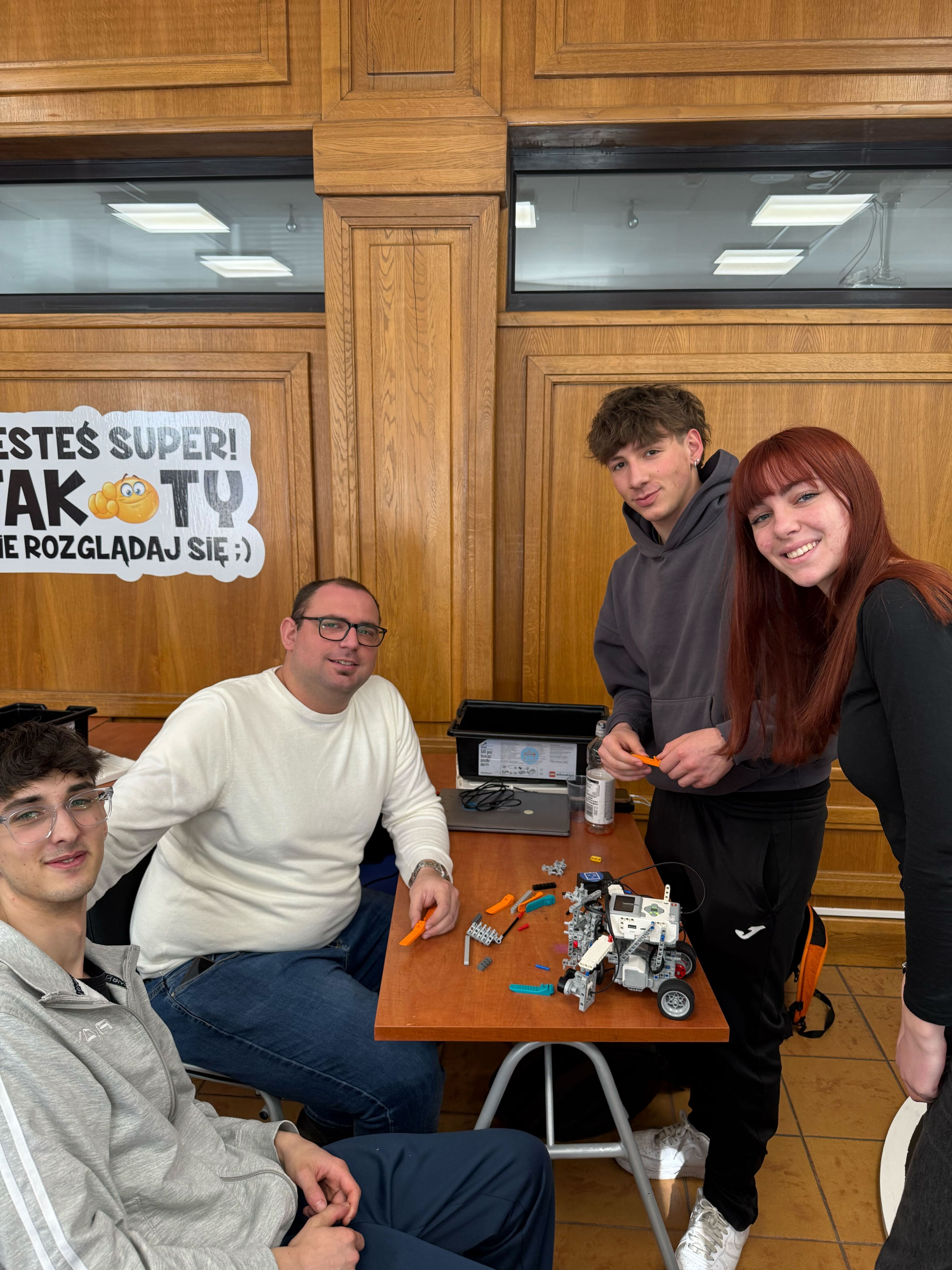 Students and teacher with a robot they built