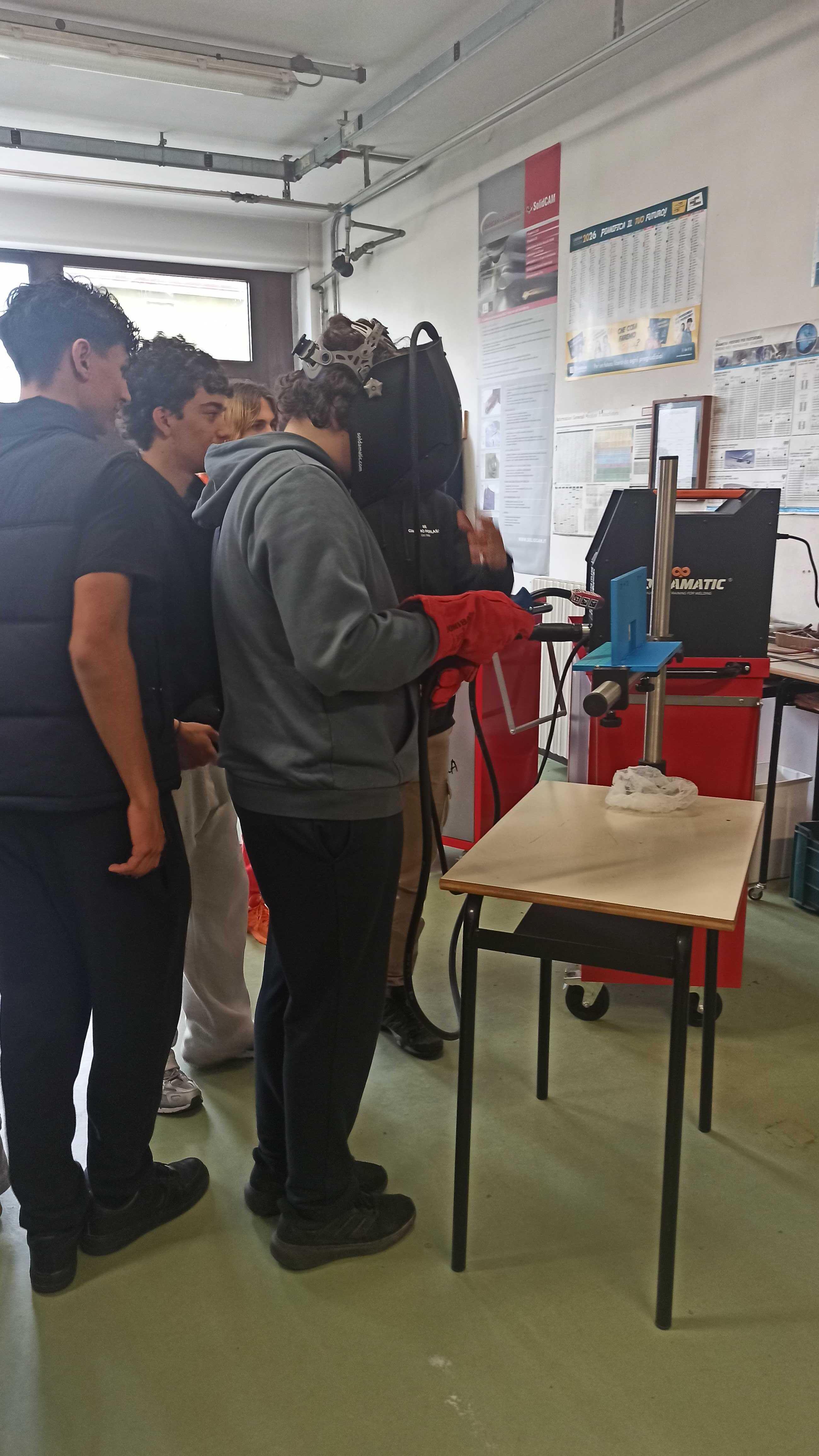 Students trying a welding simulator during a workshop